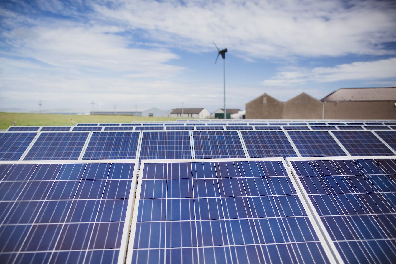 Solar panels and domestic wind turbine at Hatston, Orkney
