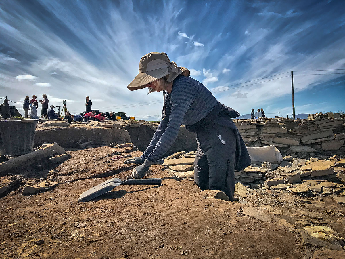 Jenny at work, carefully and patiently removing a section of the midden baulk outside Structure Ten