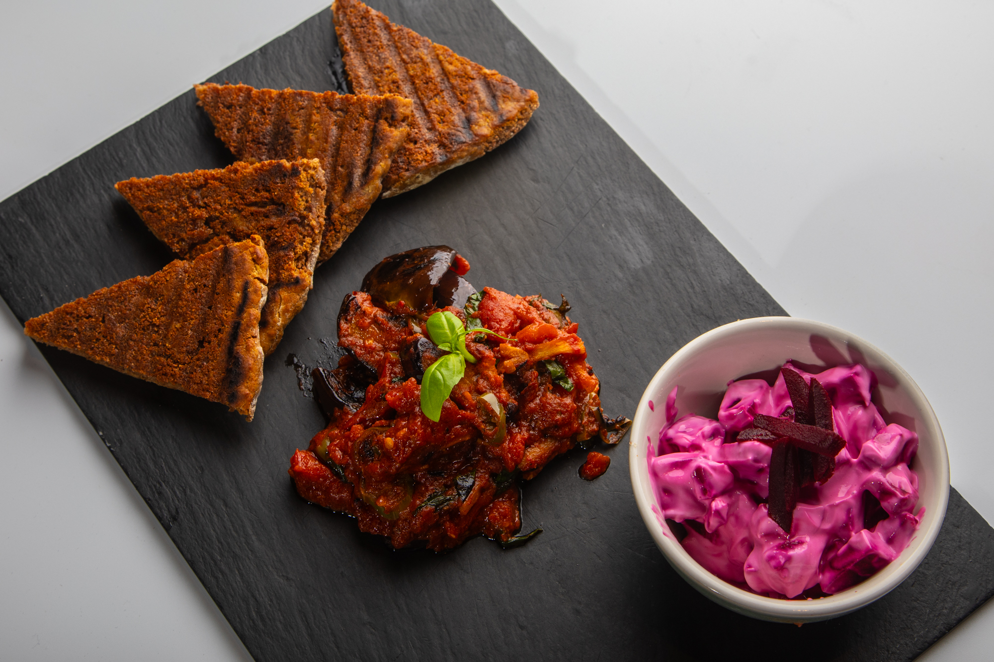Monik Mistry's charred aubergine with a spiced tomato and basil sauce, served with bere bannocks and pickled beetroot yoghurt - image by Colin Keldie