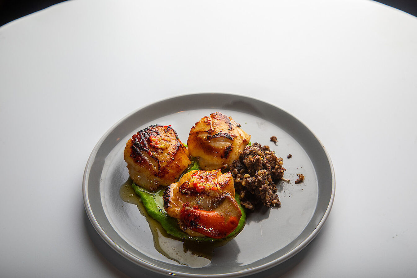 Richard Smith's seared Orkney scallops with pea puree, crispy haggis, and chilli and lime butter - image by Colin Keldie